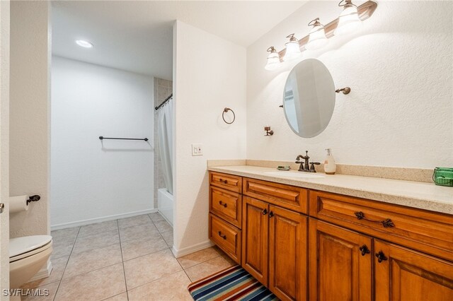 full bathroom with tile patterned flooring, vanity, shower / bath combo, and toilet