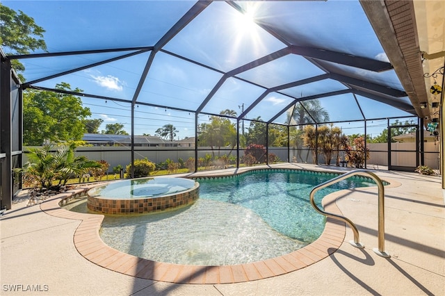 view of pool featuring a patio area, fence, a pool with connected hot tub, and a lanai