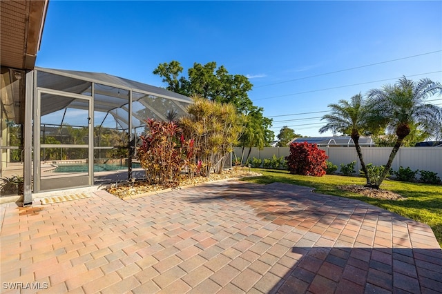 view of patio featuring a fenced in pool and glass enclosure