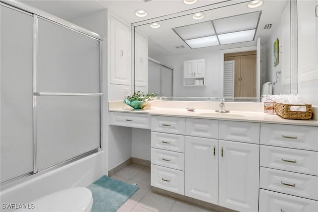 full bathroom featuring vanity, tile patterned floors, shower / bath combination with glass door, and toilet