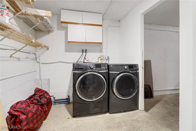 clothes washing area featuring separate washer and dryer