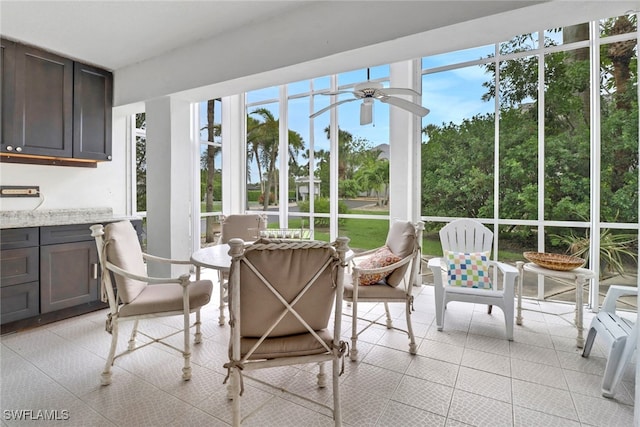 sunroom featuring ceiling fan