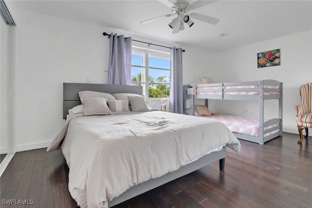 bedroom with dark hardwood / wood-style flooring and ceiling fan