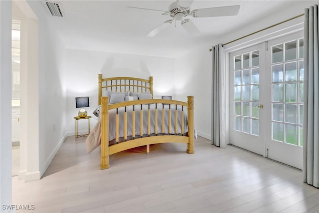 bedroom with light wood-type flooring, ceiling fan, and french doors