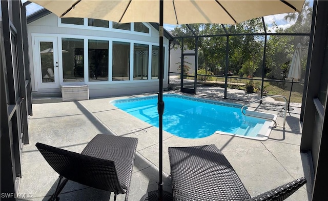 view of pool featuring a lanai and a patio