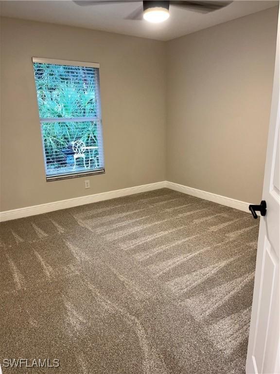 empty room featuring ceiling fan and carpet flooring