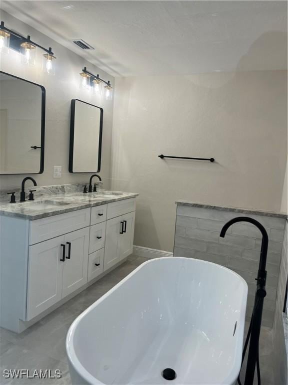 bathroom featuring vanity and a washtub