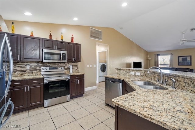 kitchen featuring dark brown cabinetry, stainless steel appliances, sink, and backsplash