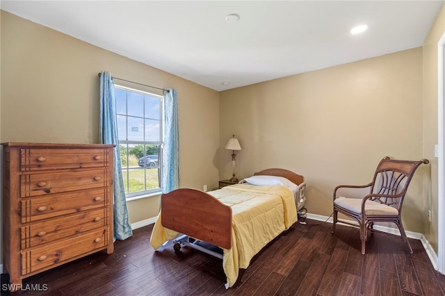 bedroom with dark wood-type flooring