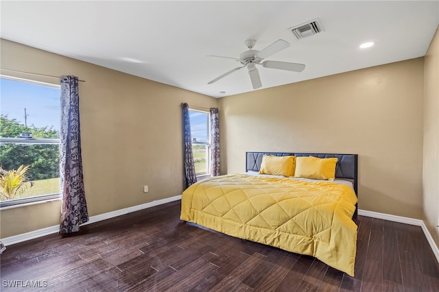 bedroom with ceiling fan and dark hardwood / wood-style flooring