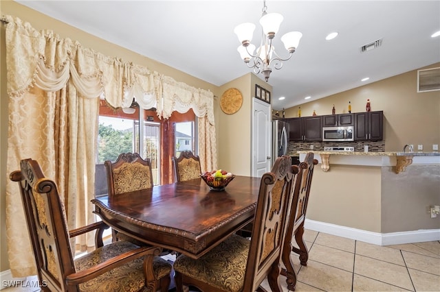 tiled dining area with lofted ceiling and a chandelier