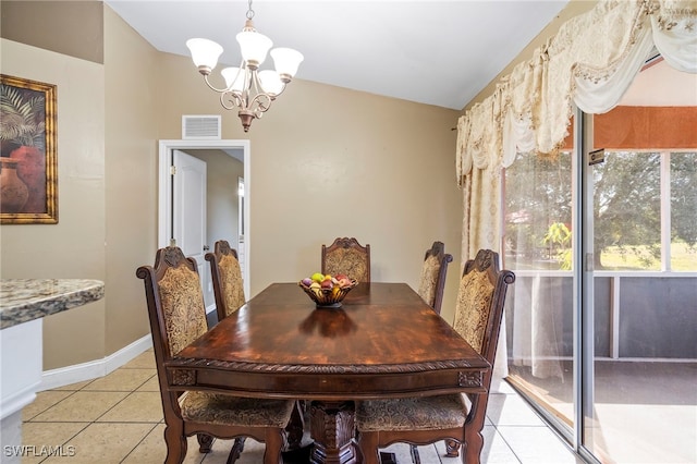 tiled dining room with vaulted ceiling and a chandelier