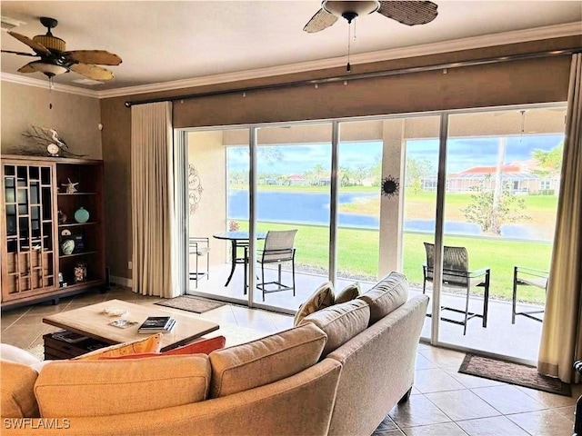 tiled living room featuring crown molding, ceiling fan, and a water view