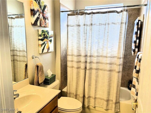 full bathroom featuring toilet, vanity, and shower / bathtub combination with curtain