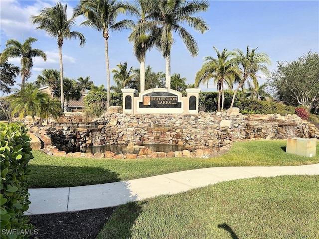 community sign featuring a lawn