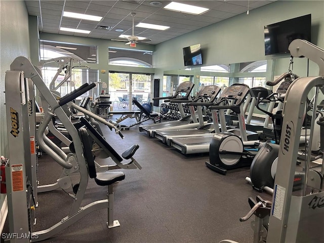 workout area with ceiling fan, visible vents, and a paneled ceiling