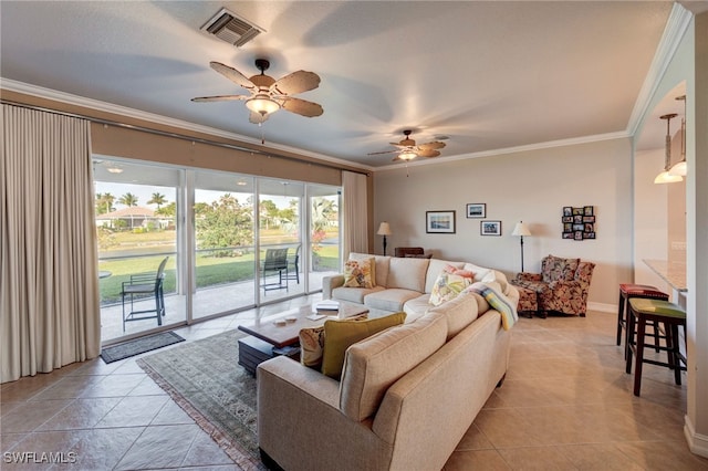 living area featuring light tile patterned floors, ceiling fan, visible vents, baseboards, and crown molding