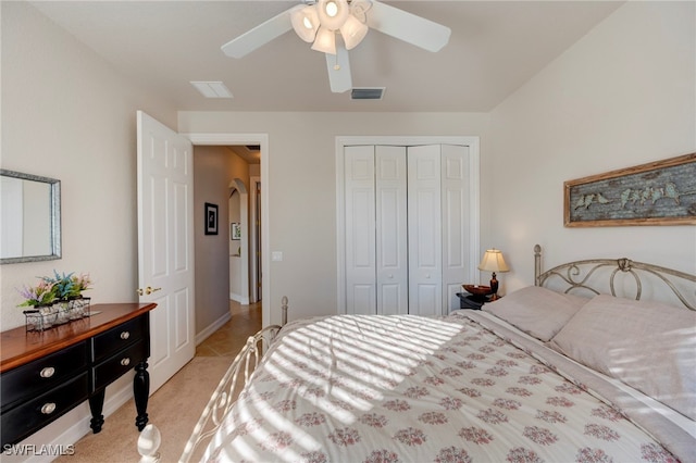 bedroom featuring a ceiling fan, light colored carpet, a closet, and visible vents