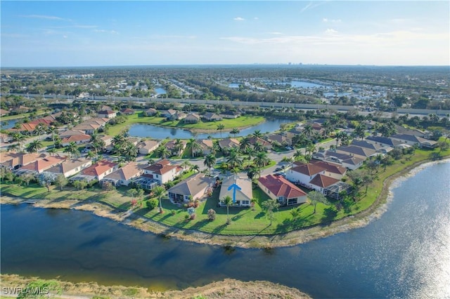 birds eye view of property featuring a water view and a residential view