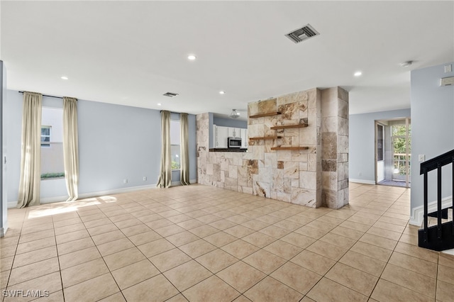 unfurnished living room with light tile patterned flooring