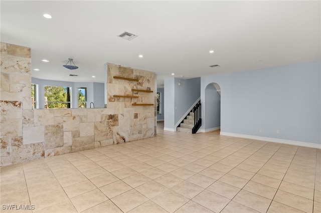 unfurnished living room featuring light tile patterned flooring