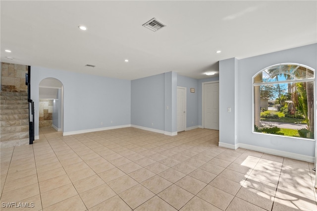 spare room featuring light tile patterned flooring