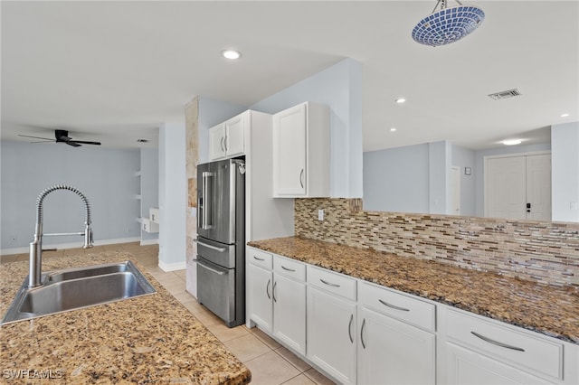 kitchen featuring white cabinetry, sink, backsplash, dark stone counters, and high end fridge