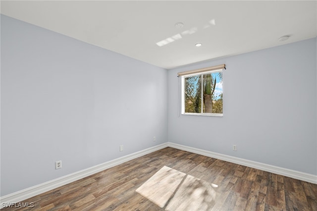 spare room with dark hardwood / wood-style floors