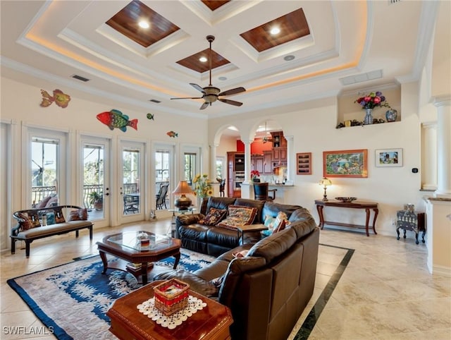 living room featuring ceiling fan, decorative columns, a high ceiling, coffered ceiling, and ornamental molding