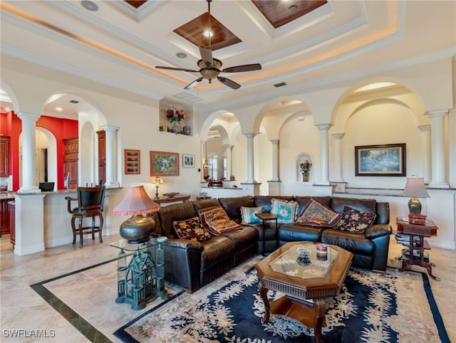 living room featuring ornate columns, crown molding, and ceiling fan