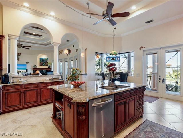 kitchen featuring sink, dishwasher, a kitchen island with sink, a tray ceiling, and ornamental molding