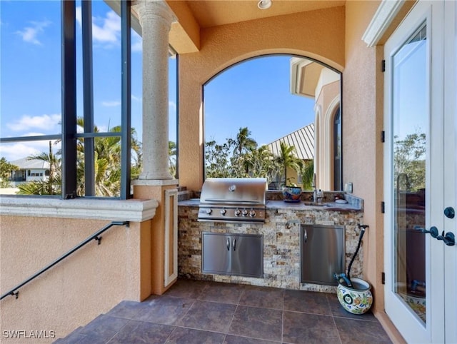 view of patio with an outdoor kitchen, grilling area, and sink