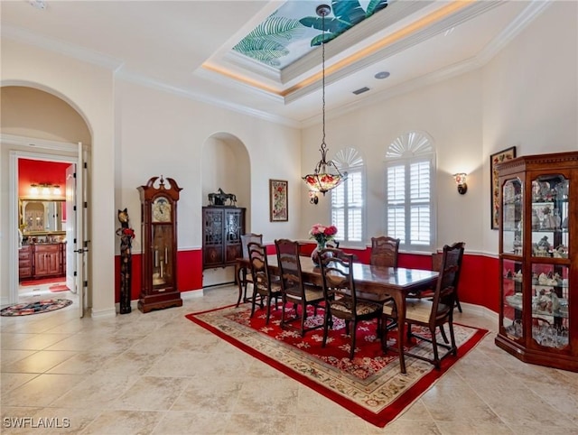 dining room with crown molding and a tray ceiling