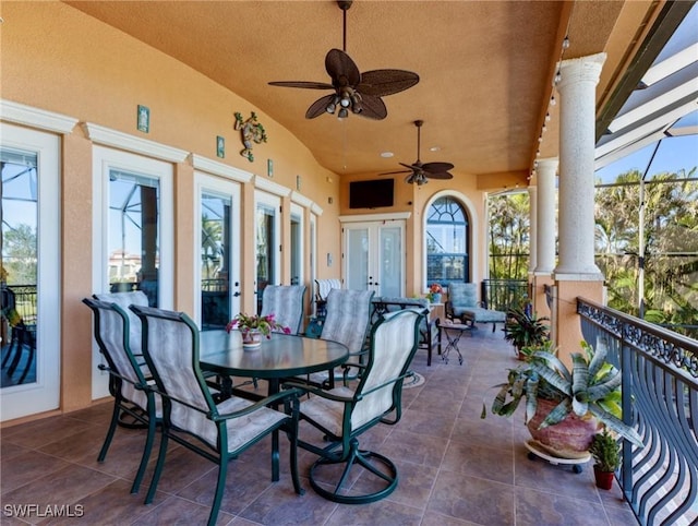 view of patio featuring french doors, ceiling fan, and glass enclosure