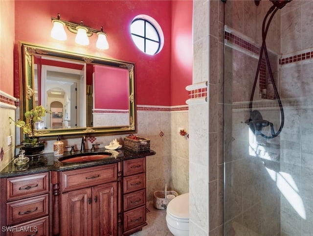 bathroom featuring vanity, an enclosed shower, and toilet