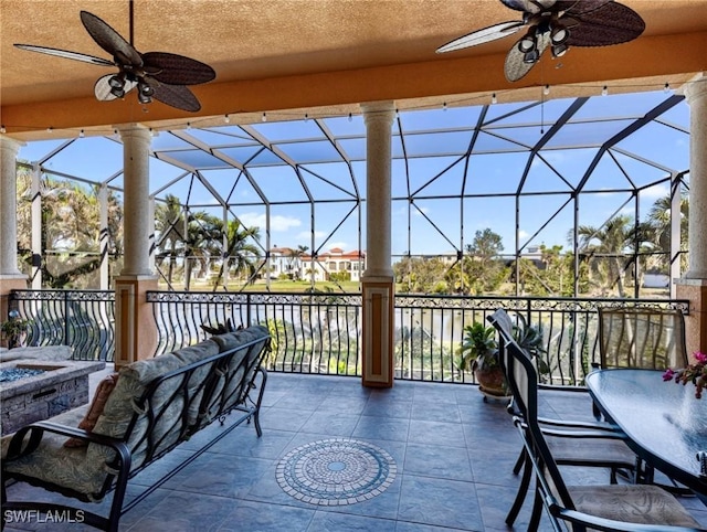 view of patio / terrace with ceiling fan and glass enclosure