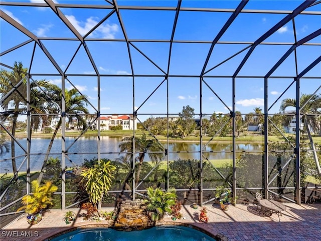 view of pool with a water view, a patio, and a lanai