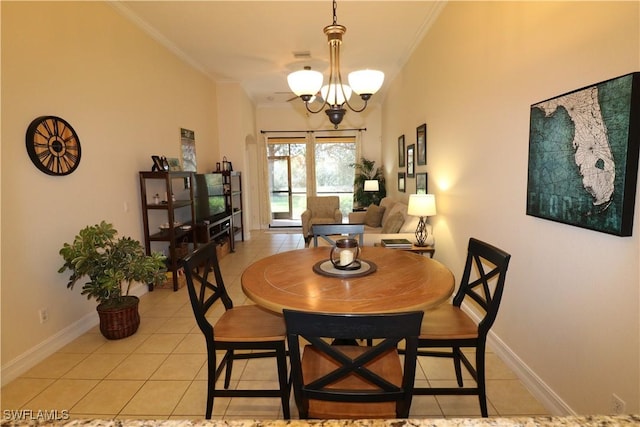 dining room featuring a notable chandelier, crown molding, and light tile patterned floors