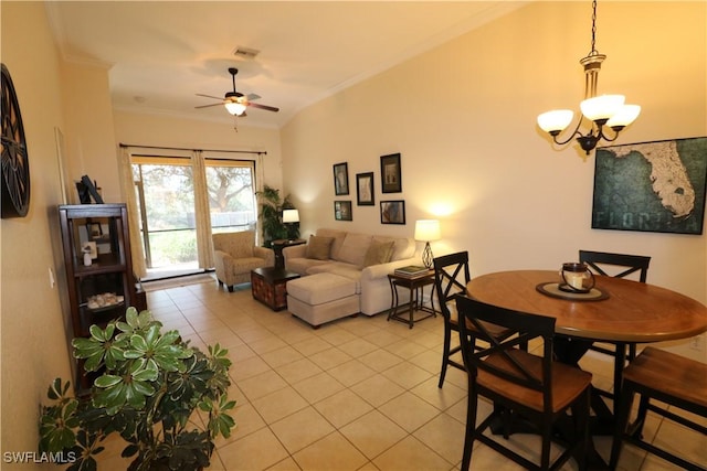 dining room featuring crown molding, ceiling fan with notable chandelier, and light tile patterned floors