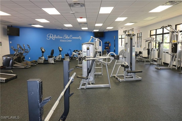 gym with a paneled ceiling