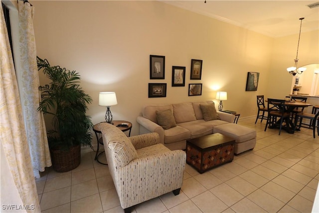 living room featuring crown molding, a chandelier, and light tile patterned floors