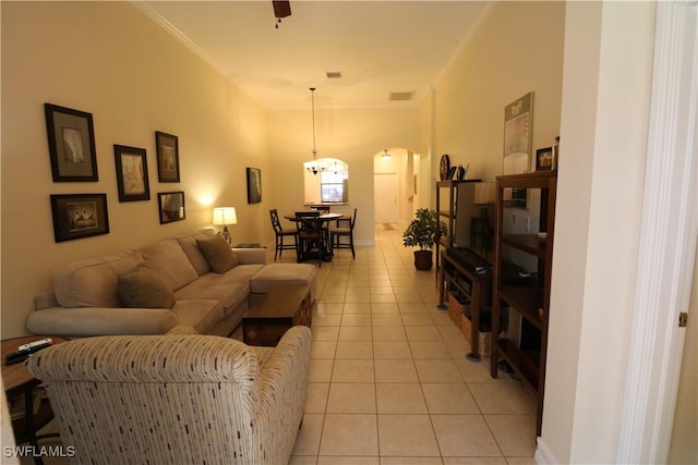 living room with ornamental molding and light tile patterned floors