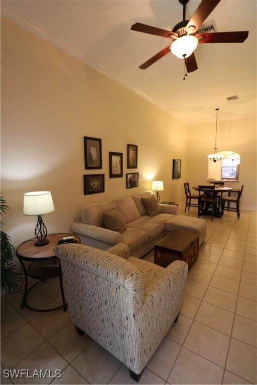 tiled living room featuring ornamental molding and ceiling fan