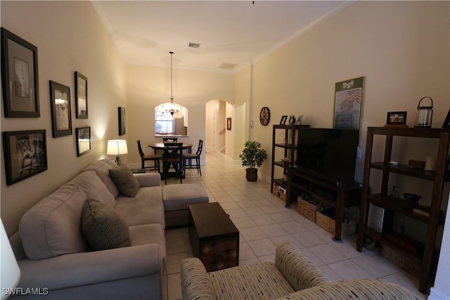 living room featuring light tile patterned floors and crown molding