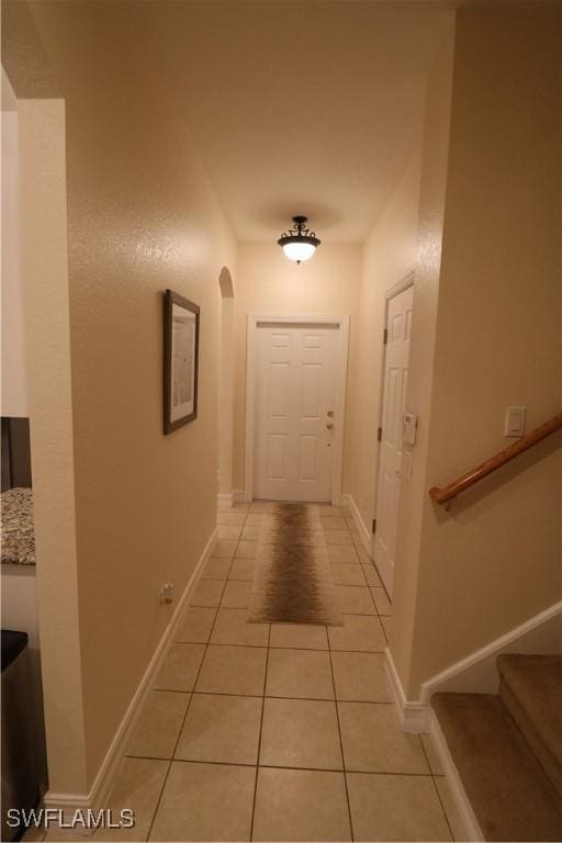 hall featuring light tile patterned flooring