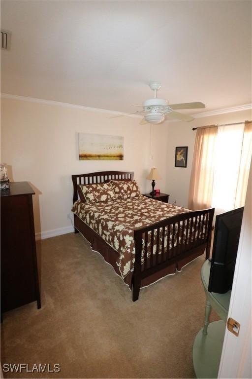 carpeted bedroom featuring crown molding and ceiling fan