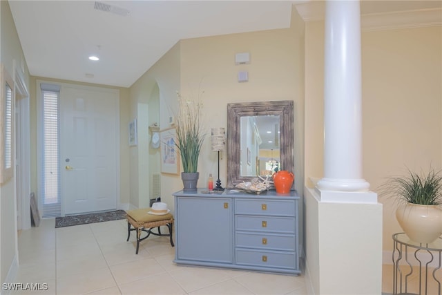 tiled foyer featuring ornate columns