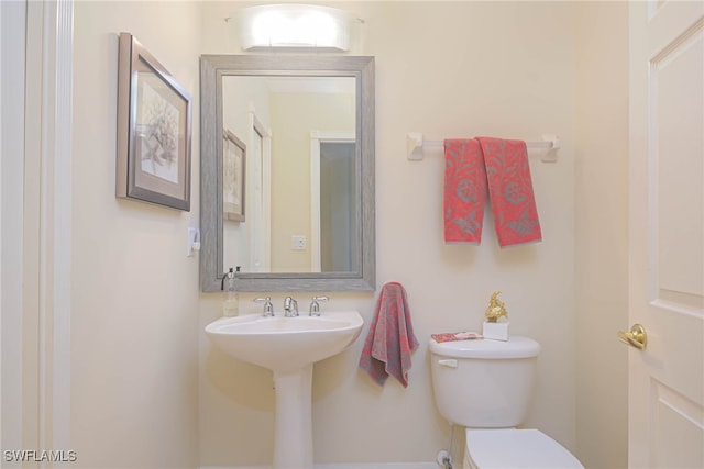 bathroom featuring sink and toilet