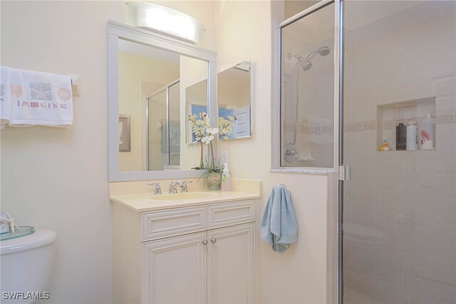 bathroom with vanity, toilet, and walk in shower