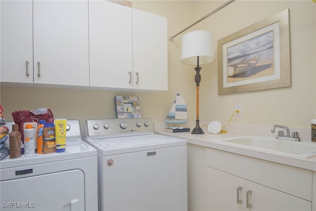 laundry area featuring cabinets, sink, and washing machine and dryer